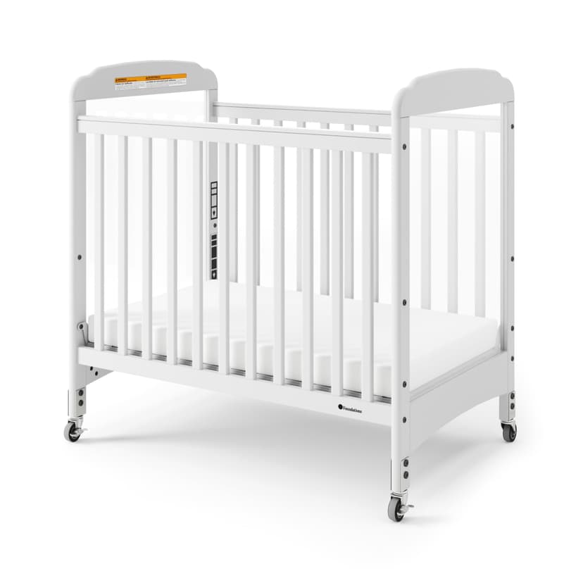 Foundations Serenity Compact Clearview Daycare Crib, Fixed Side, Durable Wood Construction, Non-Marking Casters (2 Locking), Clear End Panels, Includes 3” InfaPure Foam Mattress (White)