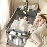 Trimigo 4-in-1 Pack and Play with Bassinet, Bedside Sleeper, Playard, and Changing Table, Folding Travel Crib with Musical Toy Rack & Bag, 4-Level Height Adjust, Newborn to Toddler（Ivy Gray）