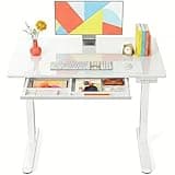 Marsail Glass Electric Standing Desk with Drawer, 40 x 24 Inches Height-Adjustable Desk, One-Piece Tempered Glass Top, Ergonomic Home Office Sit Stand Desk with 4 Preset Heights, White