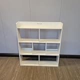 Jerrycans Bookcases White wooden multi-compartment bookcase for storing books, decorative items, and office supplies.